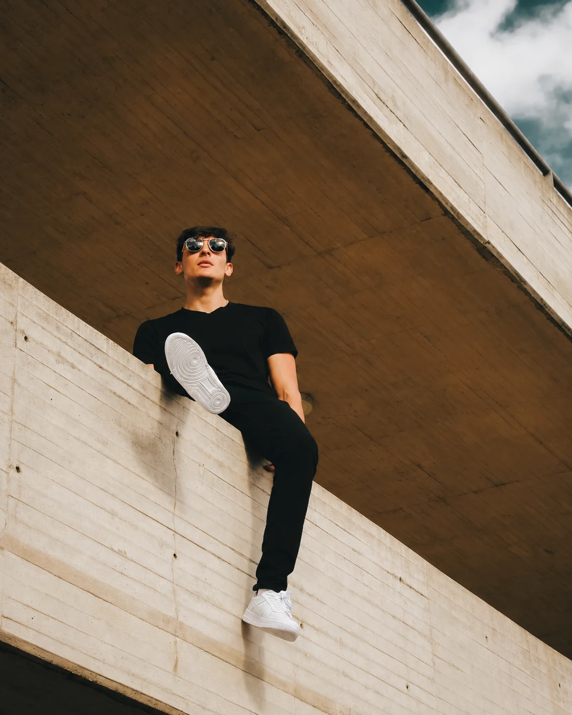 Felipe Turriago seated in a concrete architectural space